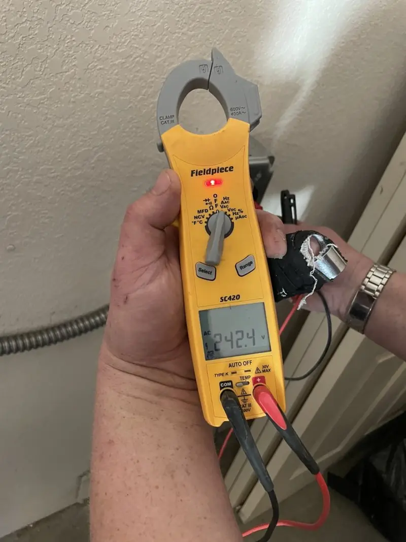 Voltage testing with clamp meter during Outlet Installation in Lyons